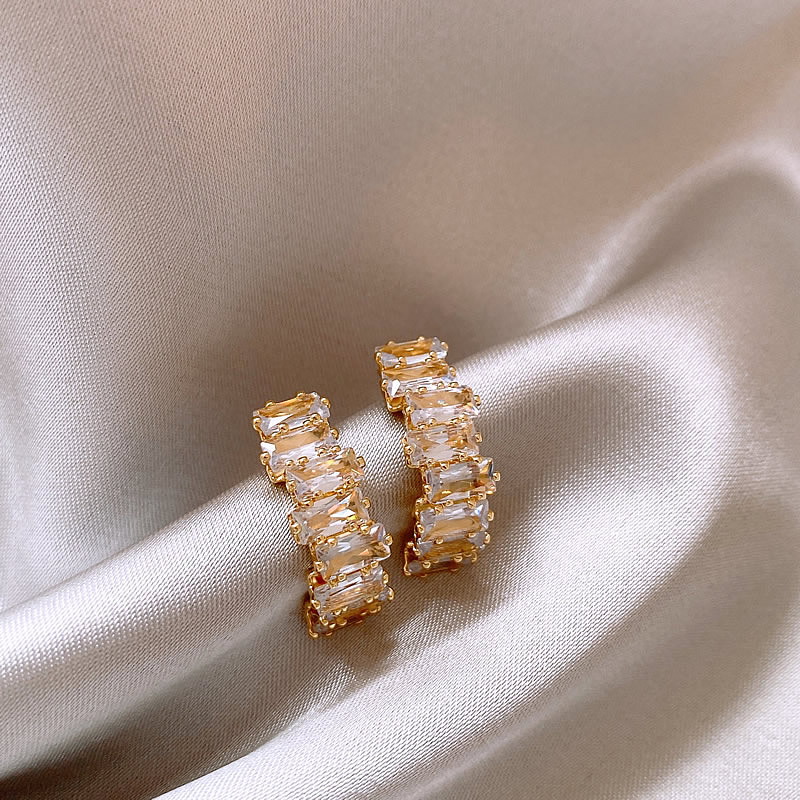 Elegant gold earrings with zircon sparkle