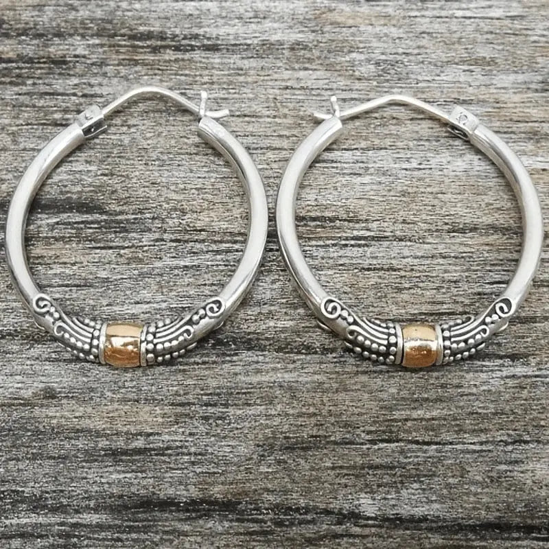 Vintage silver hoop earrings with sculpted pattern